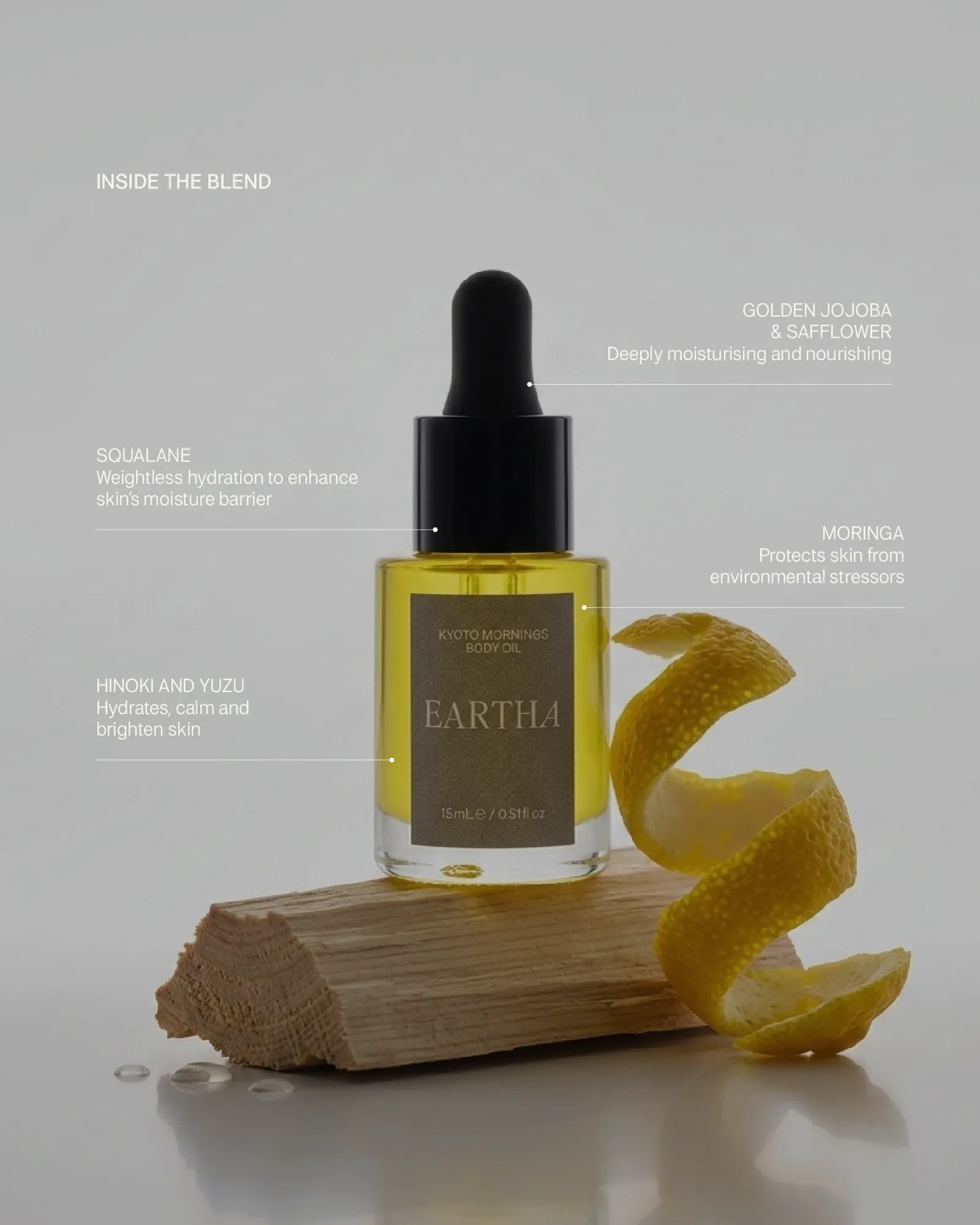Eartha skincare dropper bottle with yuzu peel on a block of hinoki wood