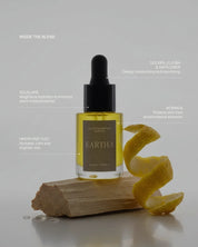 Eartha skincare dropper bottle with yuzu peel on a block of hinoki wood