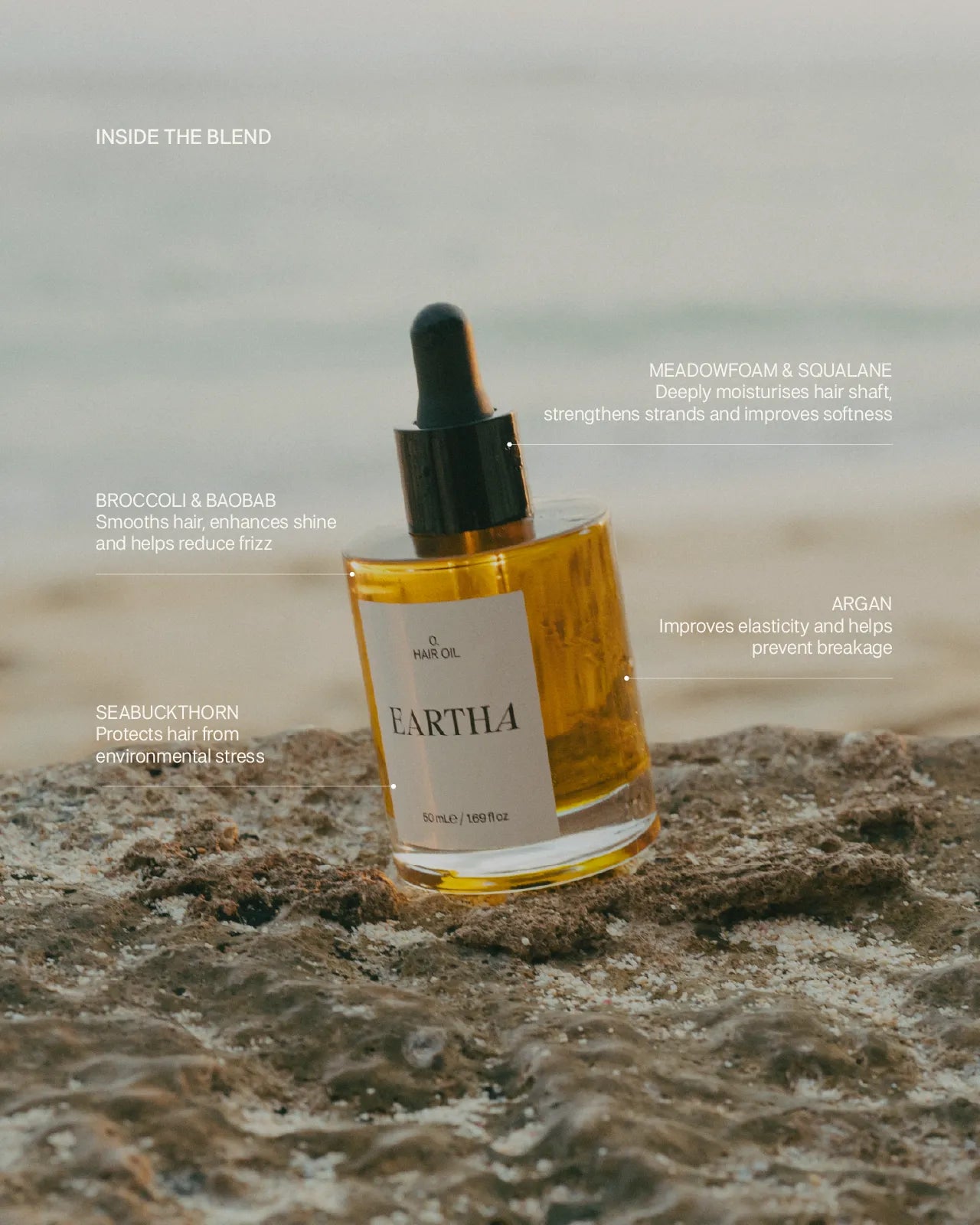 Eartha hair oil bottle on a rocky surface with text about ingredients