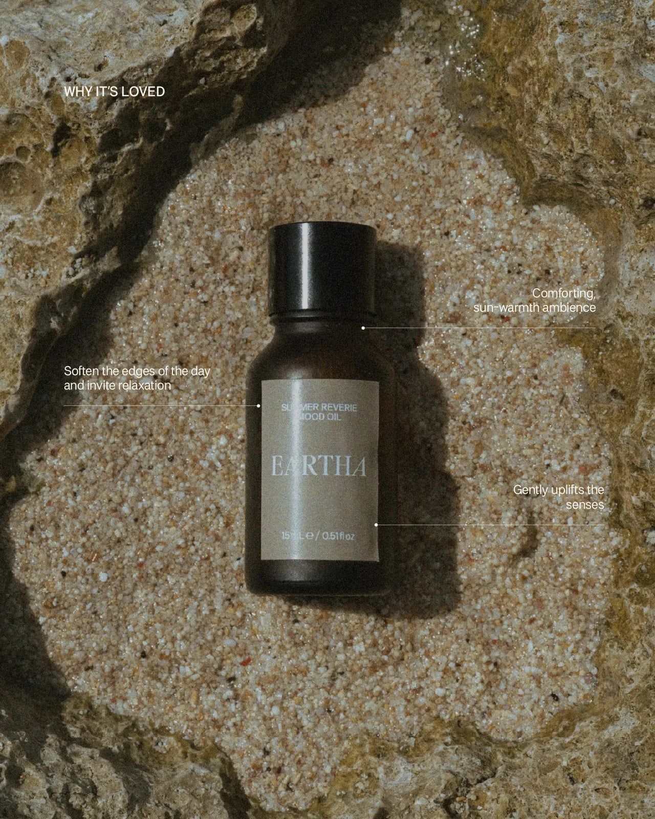 Bottle of Eartha essential oil on a textured stone surface